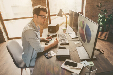 Profile side photo of focused guy sit desk look monitor computer screen see charts funds statistics...
