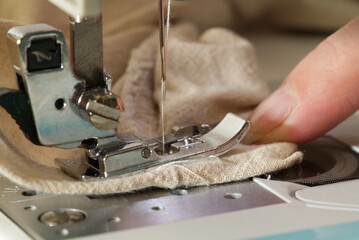 Sewing machine with focus on needle, shallow depth of field