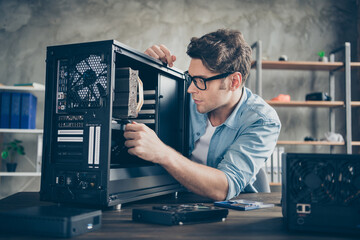 Close-up portrait of his he serious nice attractive focused guy geek skilled technician repairing...