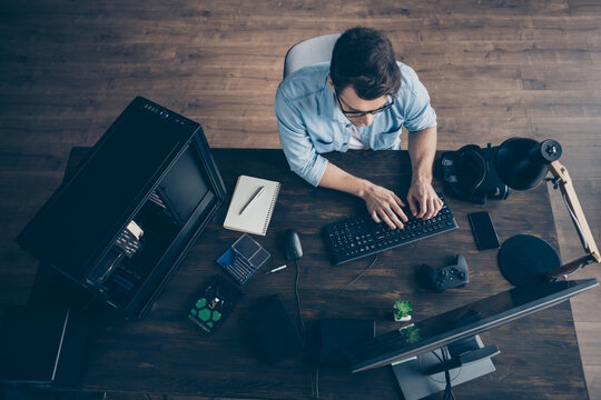 Top Above High Angle View Of His He Nice Focused Guy Geek Expert Specialist Typing E-commerce Project Start-up Innovation Security Data At Modern Wooden Industrial Office Workplace Workstation