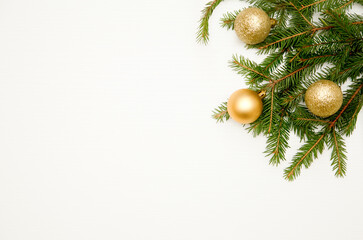 Spruce branches with balls on a white wooden background. View from above. Flat lay. Christmas composition