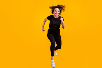 Fototapeta na wymiar Full length body size view of lovely sportive cheerful purposeful girl jumping running isolated bright yellow color background
