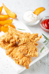 Chicken strips with French fries and sauces