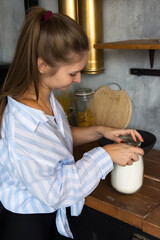 Cheerful smiling woman cooking in the kitchen