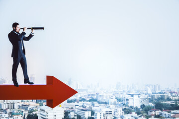 Businessman standing on red arrow and using binoculars - obrazy, fototapety, plakaty