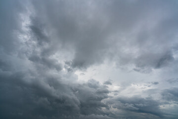 Dark dramatic sky and clouds. Background for death and sad concept. Gray sky and fluffy white clouds. Thunder and storm sky. Sad and moody sky. Nature background. Dead abstract background. Cloudscape.