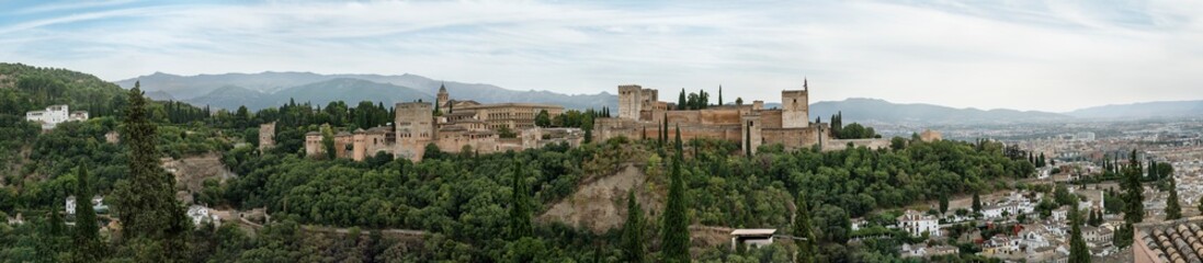 Fototapeta premium Panoramic shot of Alhambra Palace from Albacin point of view Granada, Andalucia, Spain - September 2020. Cloudy autmn day.