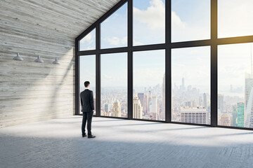 Fototapeta na wymiar Businessman standing in modern loft interior