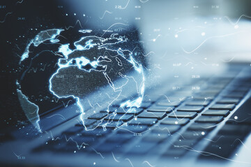 Laptop with digital world map hologram.