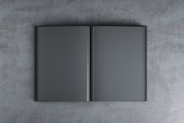 Abstract open black book standing on concrete table.