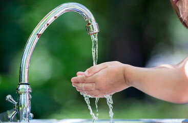 Hands open for drinking tap water. Pouring fresh healthy drink. Good habit. Right choice. Child...