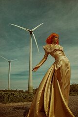 Portrait of a beautiful young woman with an orange bob haircut, wearing a long shiny golden dress,...