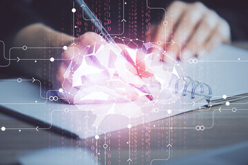 Multi exposure of writing hand on background with brain hologram. Concept of learning.