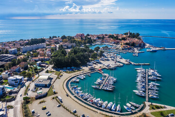 An aerial shot of coastal city Novigrad with boats and yachts in marina, Istria, Croatia