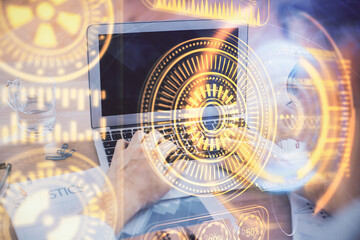 Technology theme hologram with man working on computer on background. High tech concept. Double exposure.