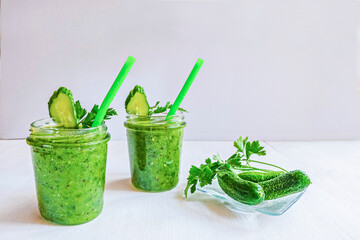 Green cocktail of spinach, lemon, cucumber and parsley on a light background. The concept of healthy nutrition, detox, green, diet, vegan, keto, fit
