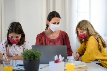 Group of homeschooling children with teacher studying indoors, coronavirus concept.