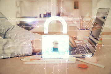 Double exposure of lock icon with man working on computer on background. Concept of network...