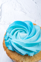 tasty Cupcake or muffin with blue cheese cream frosting on white background