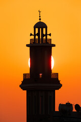 Sunrise and a Minaret in the morning,  a view from Busiateen coast, Bahrain