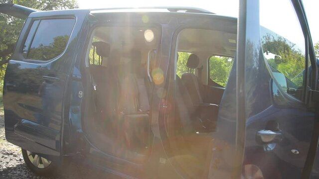 Minibus salon. Open doors. Filming outside the salon. Minibus in nature. Handheld shooting