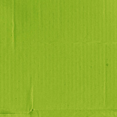 A green vintage rough sheet of carton. Recycled environmentally friendly cardboard paper texture. Simple and bright minimalist papercraft background.
