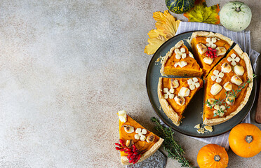 Obraz na płótnie Canvas Top view of pumpkin tart or pie with feta cheese and thyme. Fall season concept. Cozy autumn food background. Copy space.