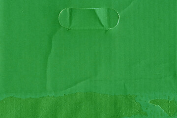 A green vintage rough sheet of carton. Recycled environmentally friendly cardboard paper texture. Simple and bright minimalist papercraft background.