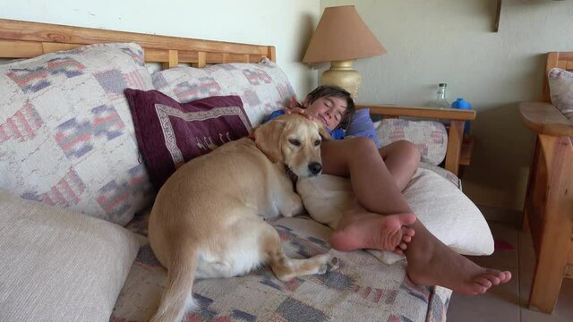 Kas, Turkey - 15th of October 2020: 4K Dog and a boy having nap on sofa
