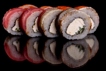 Fresh delicious beautiful sushi rolls on a dark background