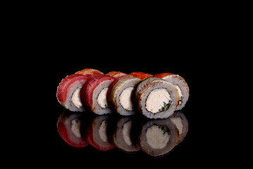 Fresh delicious beautiful sushi rolls on a dark background