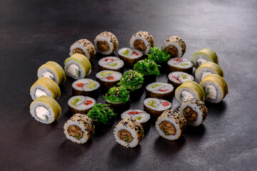 Fresh delicious beautiful sushi rolls on a dark background