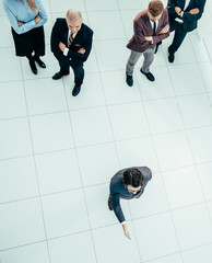 top view. leader standing in front of a group of employees.