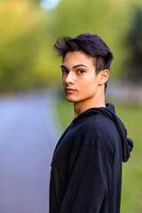 Young handsome man outdoors in fall clothing with autumn natural surroundings