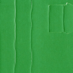 A green vintage rough sheet of carton. Recycled environmentally friendly cardboard paper texture. Simple and bright minimalist papercraft background.