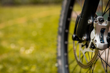 Fototapeta na wymiar Close-up of a mountain bike brake system. See worn brake disc and hydraulic brake mechanism.