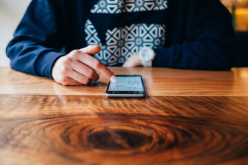 Woman using smart phone sitting at table