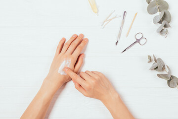 Female hands apply nourishing cream