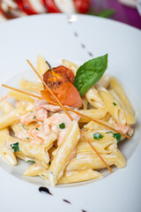Traditional Italian pasta penne with salmon and creamy sauce.