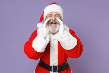 Cheerful Santa Claus man in Christmas hat red suit coat white gloves glasses screaming with hands gesture near mouth isolated on violet background. Happy New Year celebration merry holiday concept.