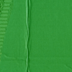 Fototapeta premium A green vintage rough sheet of carton. Recycled environmentally friendly cardboard paper texture. Simple and bright minimalist papercraft background.