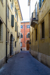 Fototapeta na wymiar Narrow empty street in the old medieval town of Verone in the Veneto Region, Italy. 