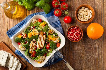 Traditional Greek salad with grilled Halloumi cheese with basil. Top view. Flat lay.