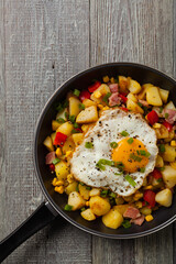 Traditional American hash with fried eggs. Top view.
