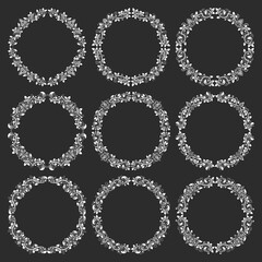Set of floral round frames in vintage style. Circular wreaths bundle in victorian style. White elements for design on black background.