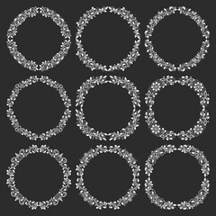 Set of floral round frames in vintage style. Circular wreaths bundle in victorian style. White elements for design on black background.