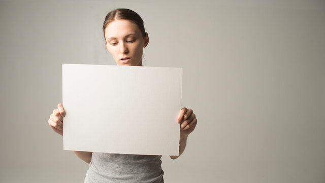 woman holding a sheet of paper in her hand