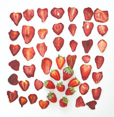 Fresh strawberries and dried strawberries slices on white background.