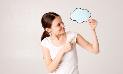 mid adult woman holding blank speech bubble on white background. Horizontal shape, front view, waist up, copy space