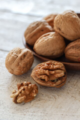 Close up shot of walnuts on a white wooden table